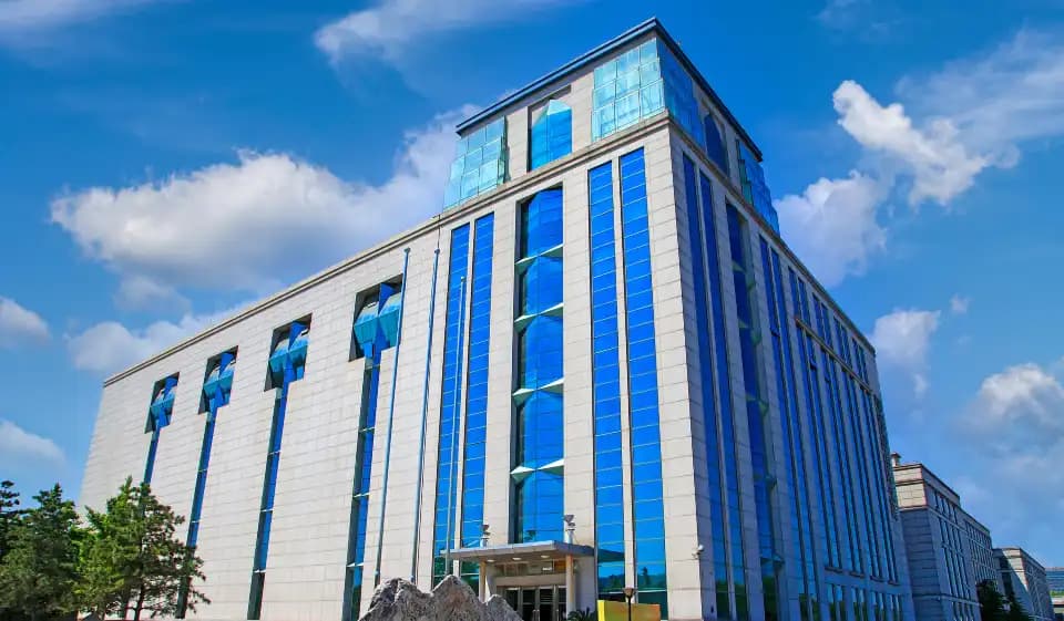 The Geological Museum of China building with a grey façade and tall blue windows