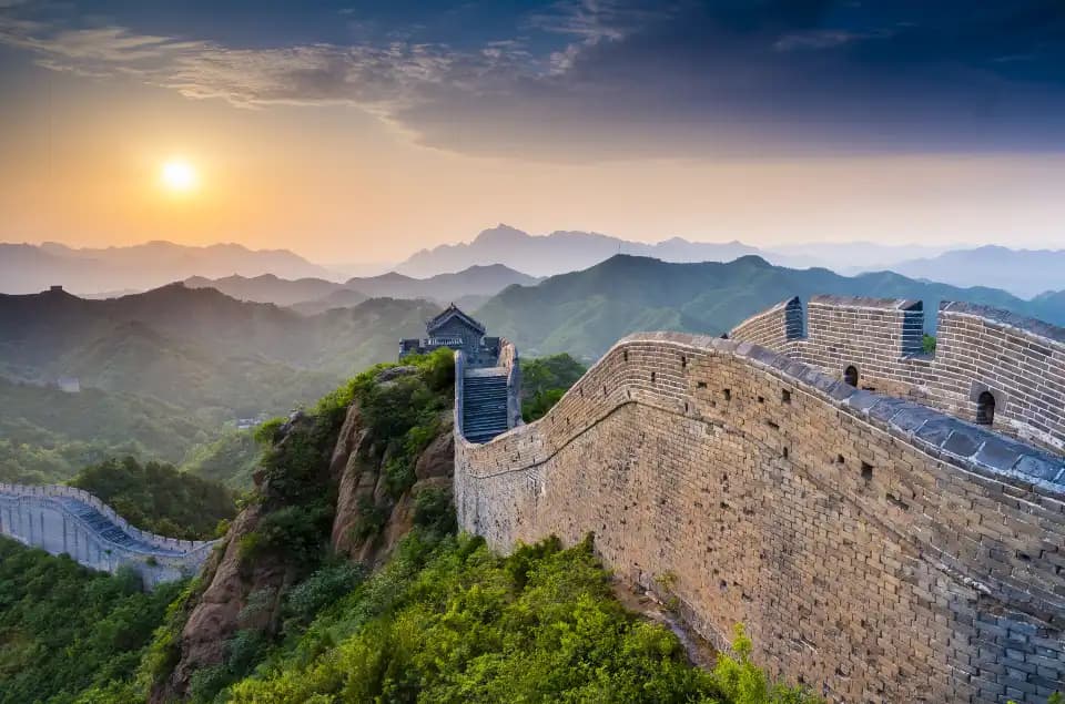 Jinshanling wall and watchtower along a mountain ridge in soft sunlight