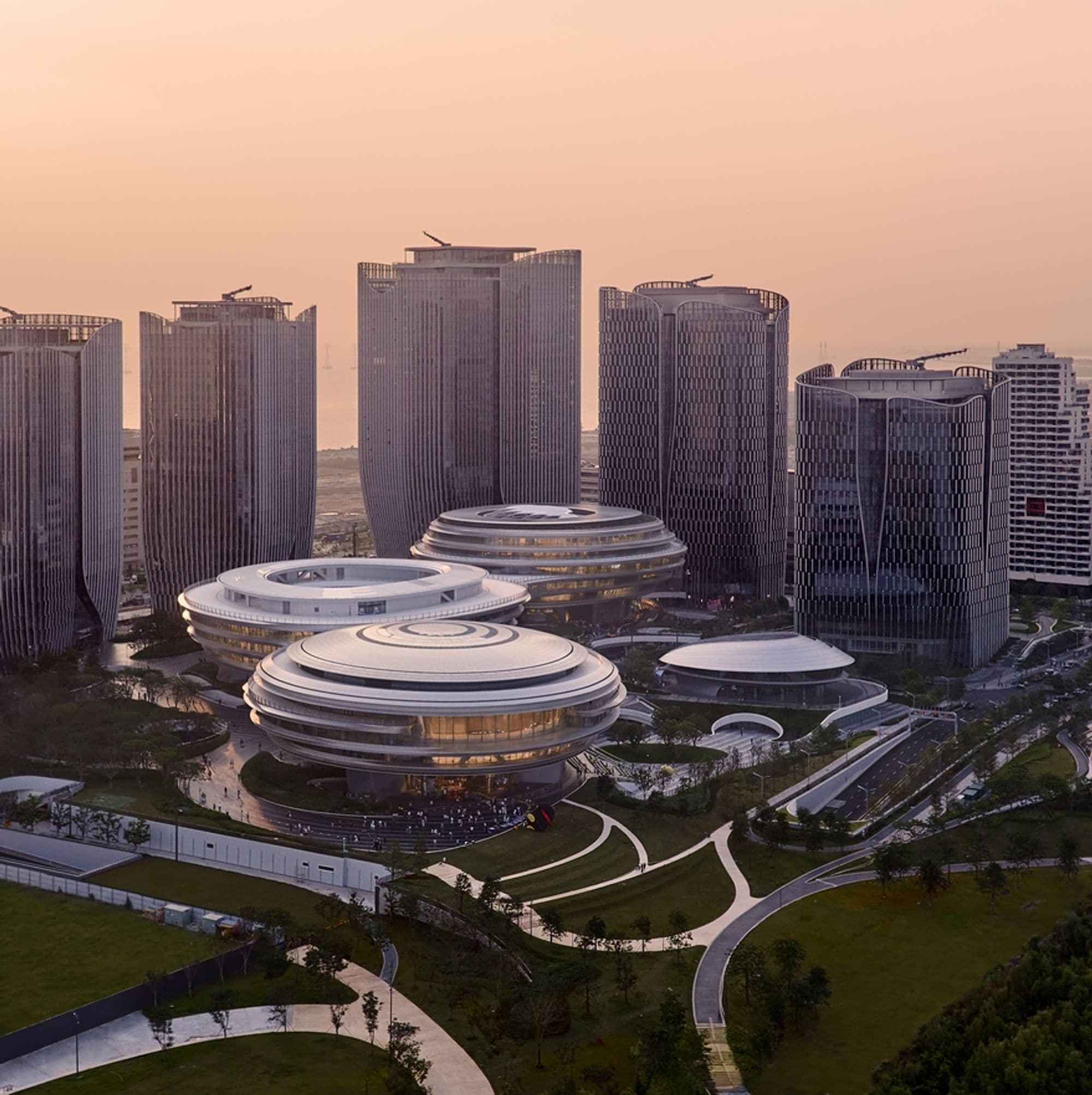 Three rounded Tengyun Center buildings in front of towers at Tencent’s Shenzhen campus